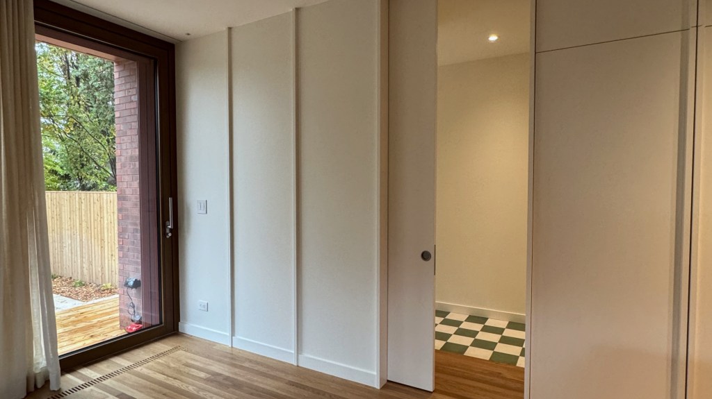 Custom flush pocket door system installation, executed with precise alignment and seamless integration into wall panels.

The project emphasizes clean detailing, smooth operation, and a high-end finish carpentry approach throughout.